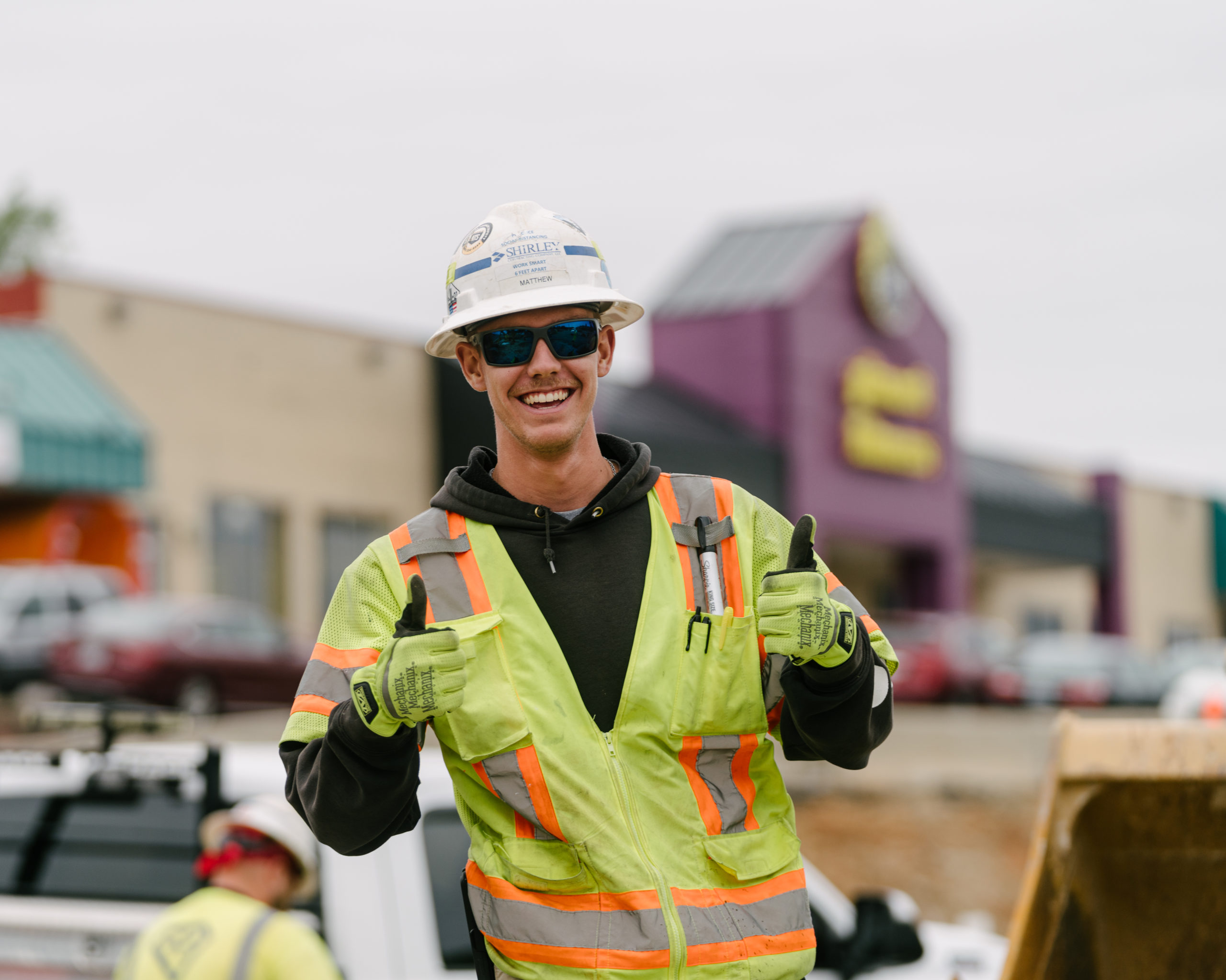 Smiling worker giving two thumbs up to the camera